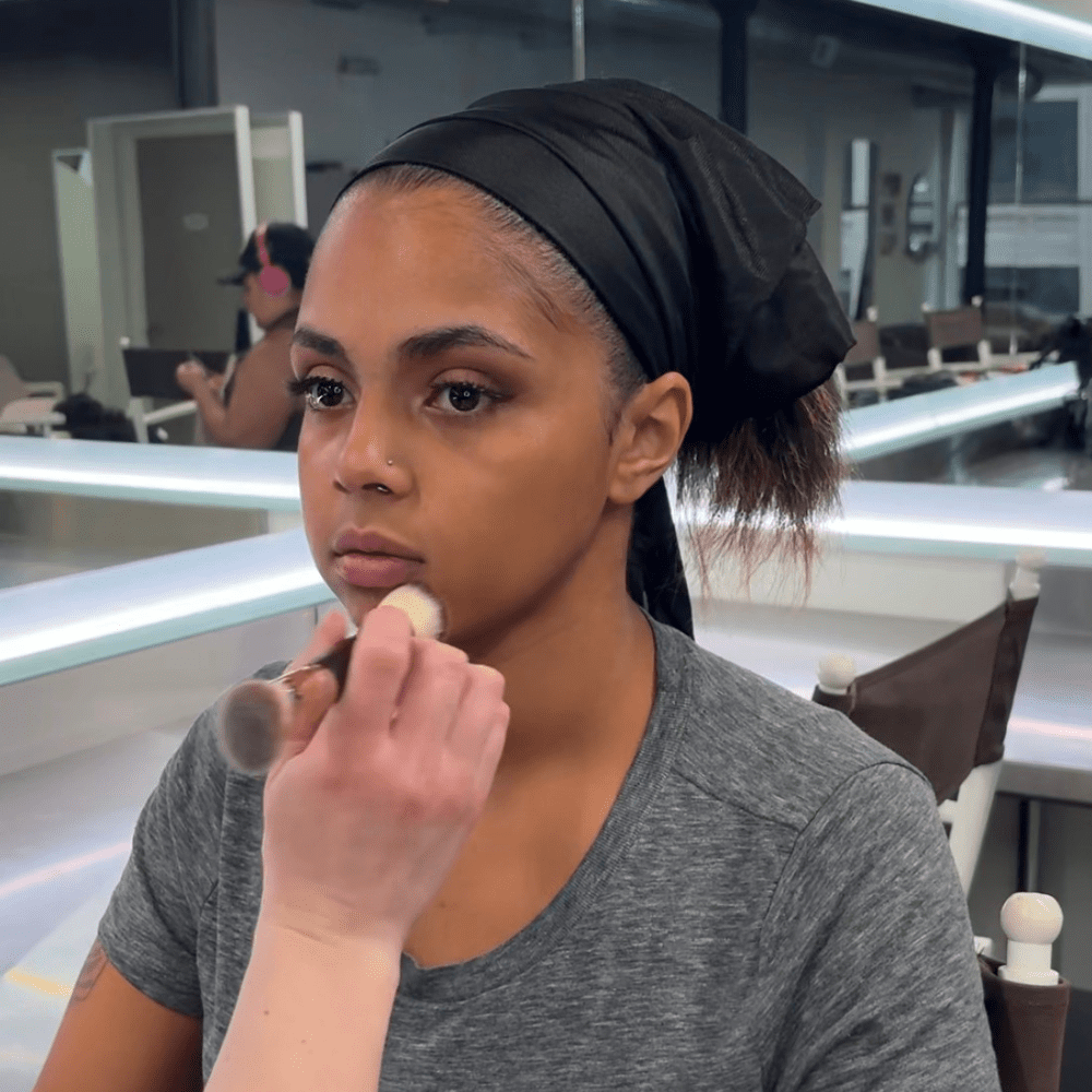 makeup artist applying foundation for long lasting makeup